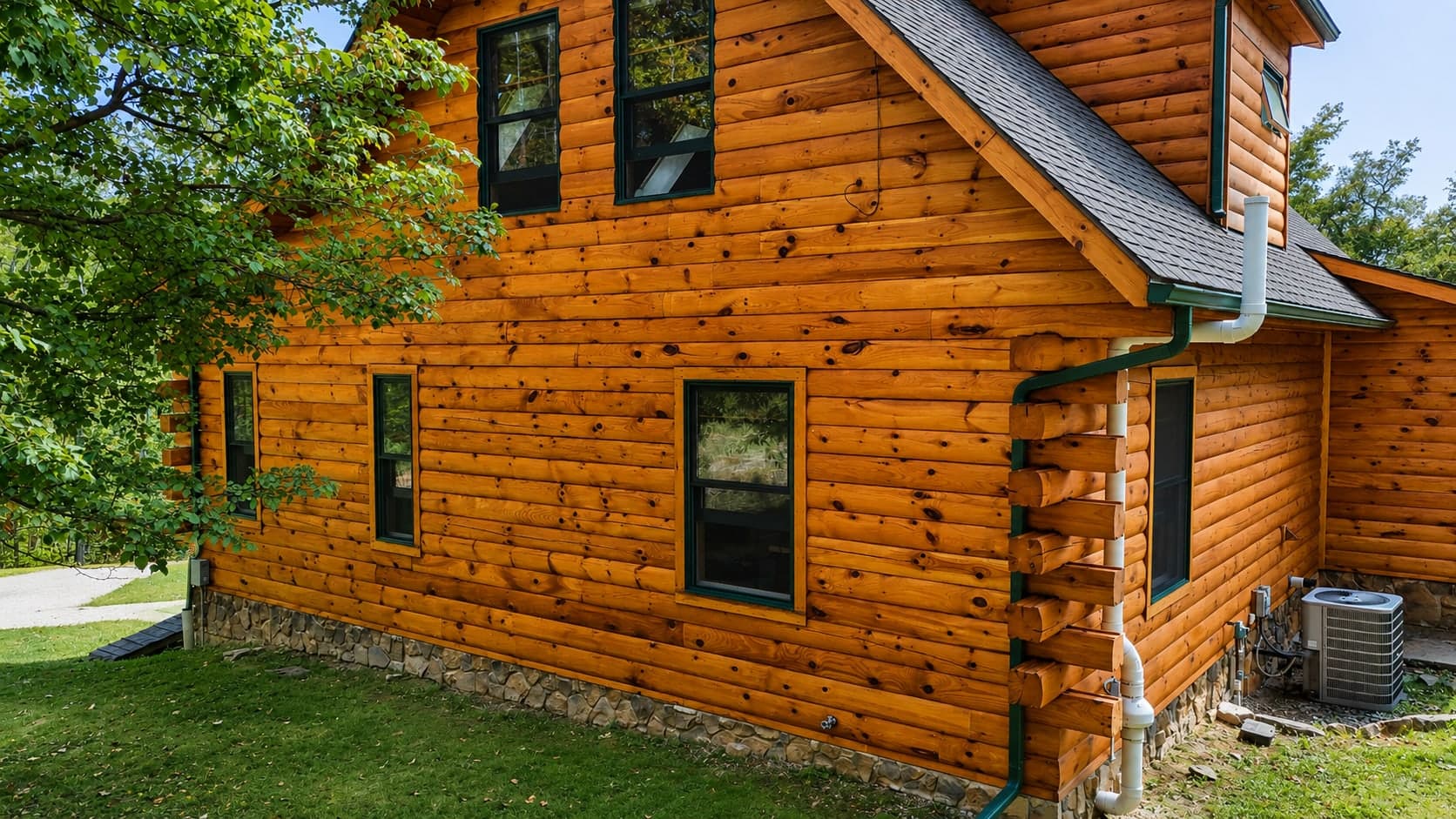 Log home exterior freshly stained, with the joints between courses sealed
